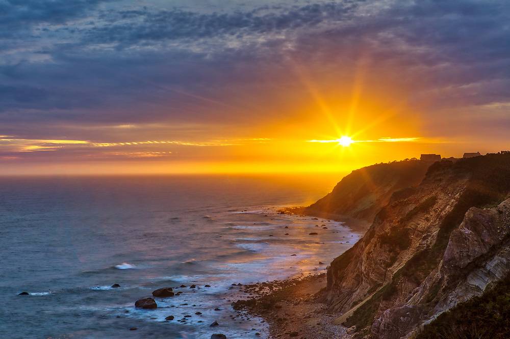 Sunset over the ocean and cliffs at Mohegan Bluffs on Block Island