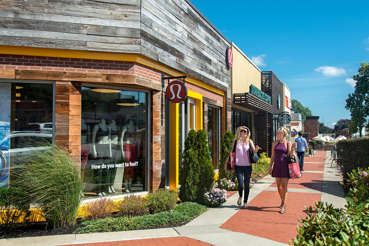Shoppers walking past stores at Garden City Center in Cranston