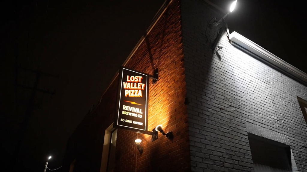 Revival Brewing Company and Lost Valley Pizza entrance at night